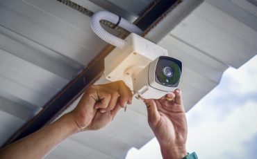 Technician installing CCTV camera system for security area
