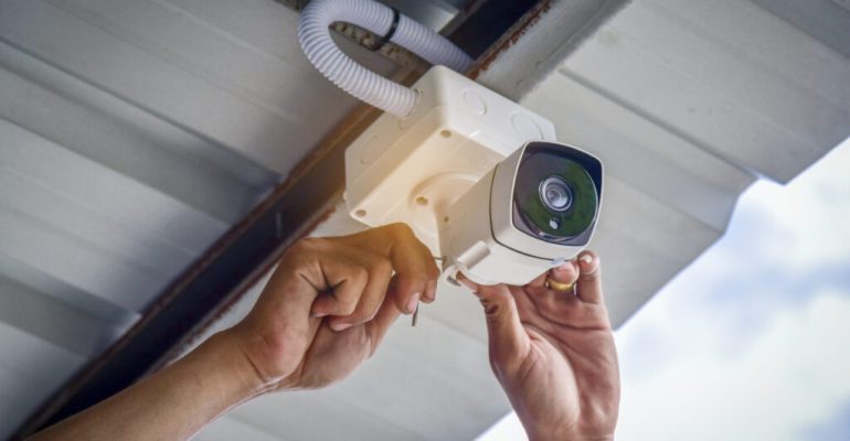 Technician installing CCTV camera system for security area